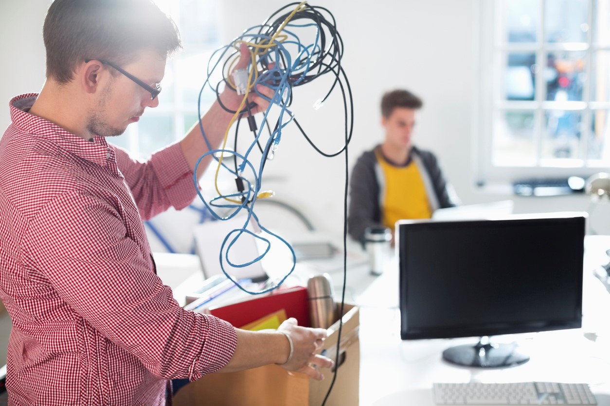 Person unpacking wires in new office